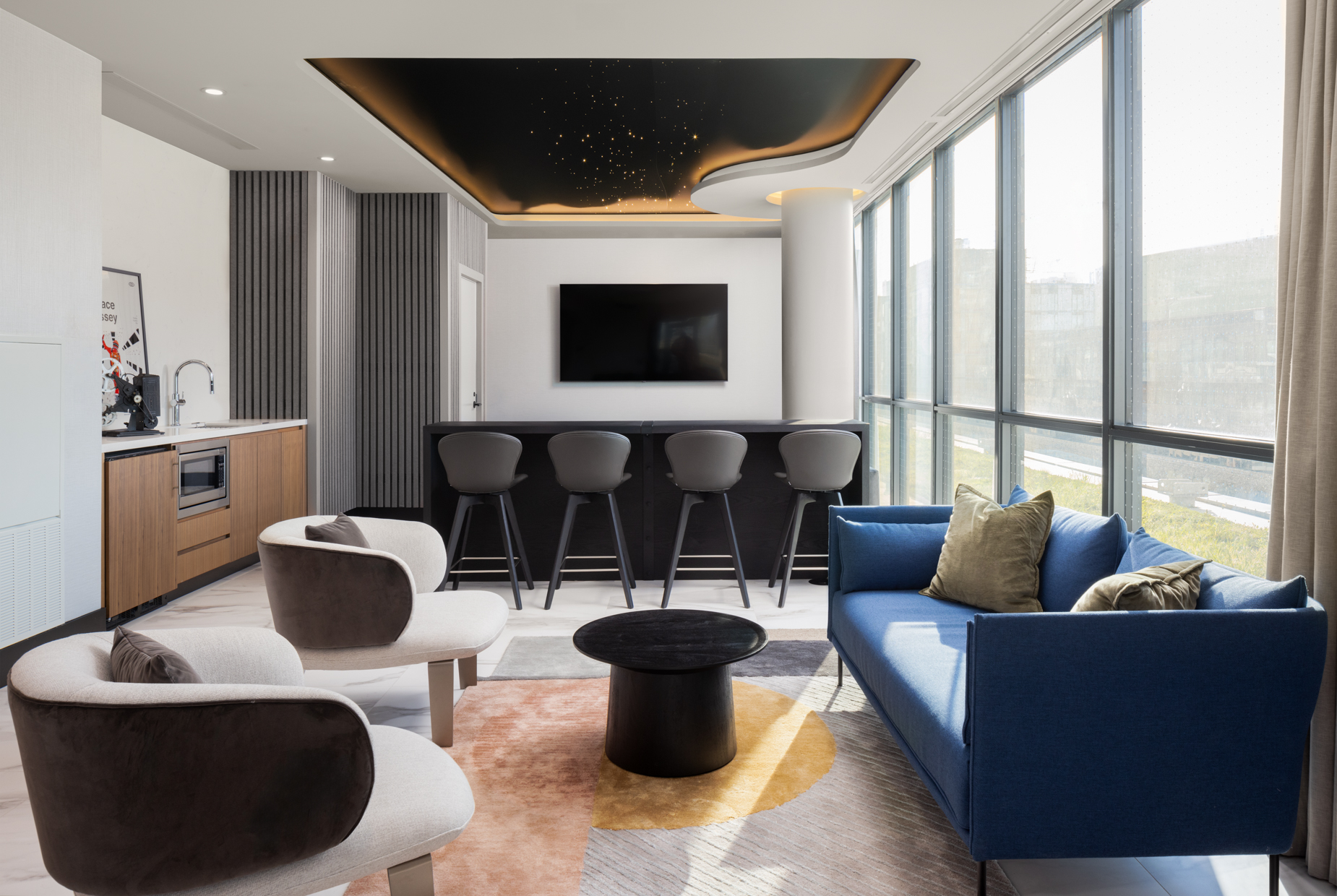 A spotless luxury apartment community clubhouse and amenity lounge with floor-to-ceiling windows